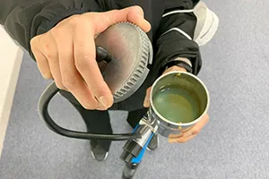 ABACスプレーガン附属の塗料カップに屋内用光触媒コーティング剤(BX01-AB1)を充填した様子